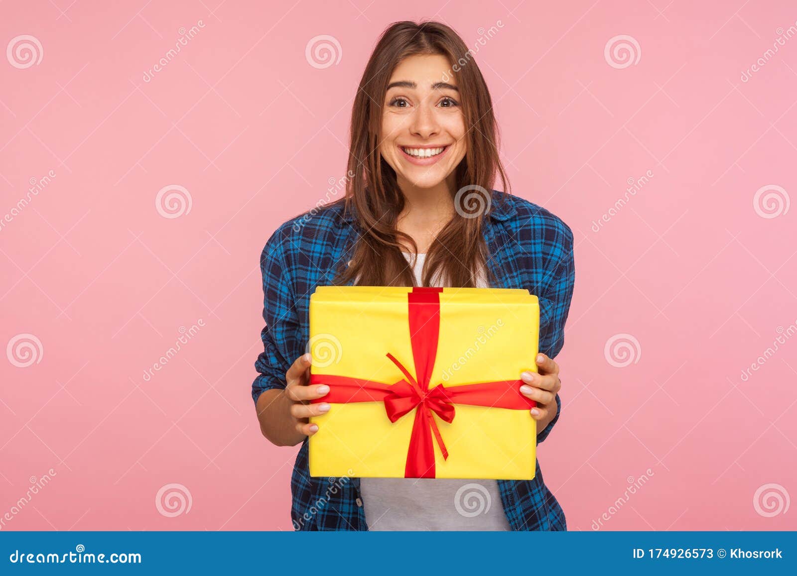 amazing bonus, holiday present! portrait of extremely happy girl in checkered shirt holding wrapped box
