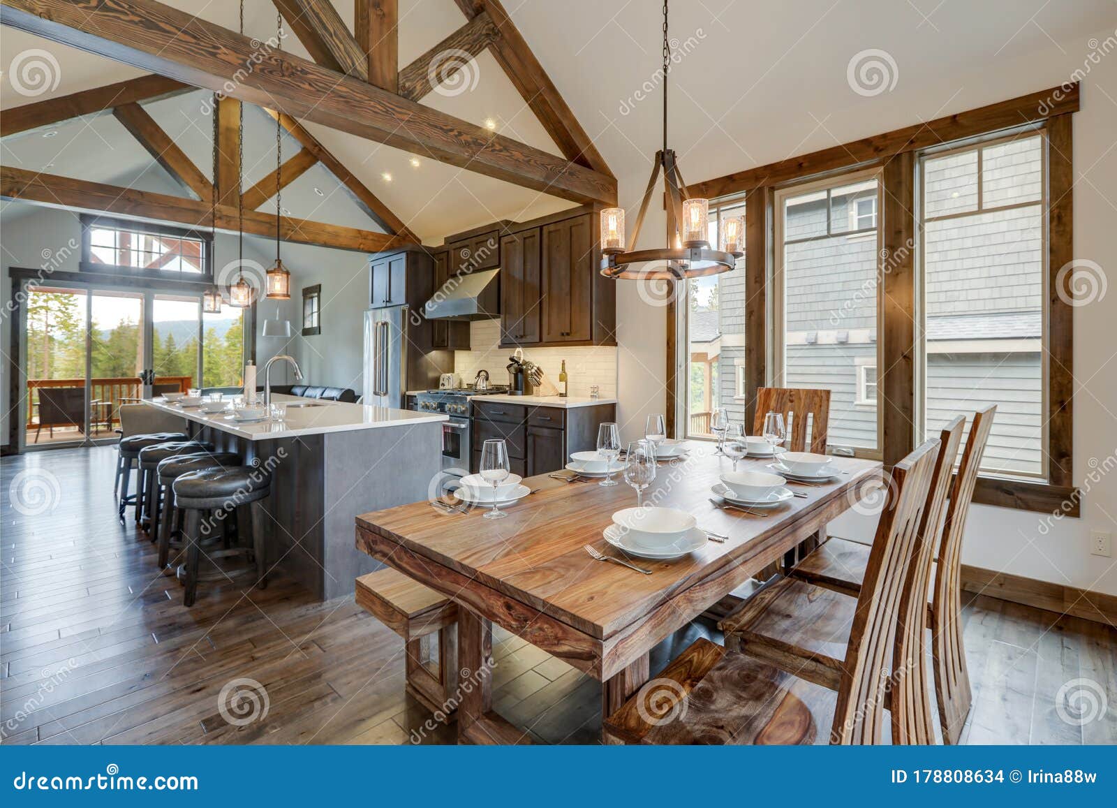 amazing dining room near modern and rustic luxury kitchen with vaulted ceiling and wooden beams, long island with white quarts