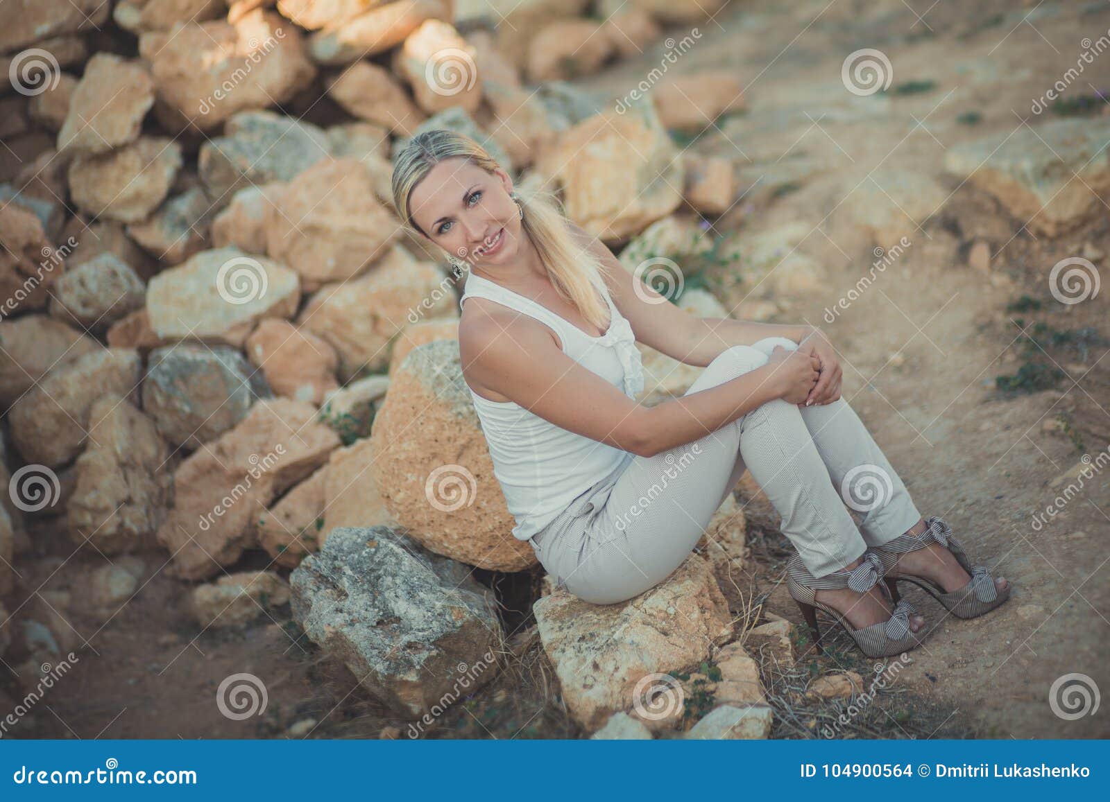 amazing lady blond woman in light white stylish clothes posing on sea side beach air.sparkler girl looking to camera on ancie
