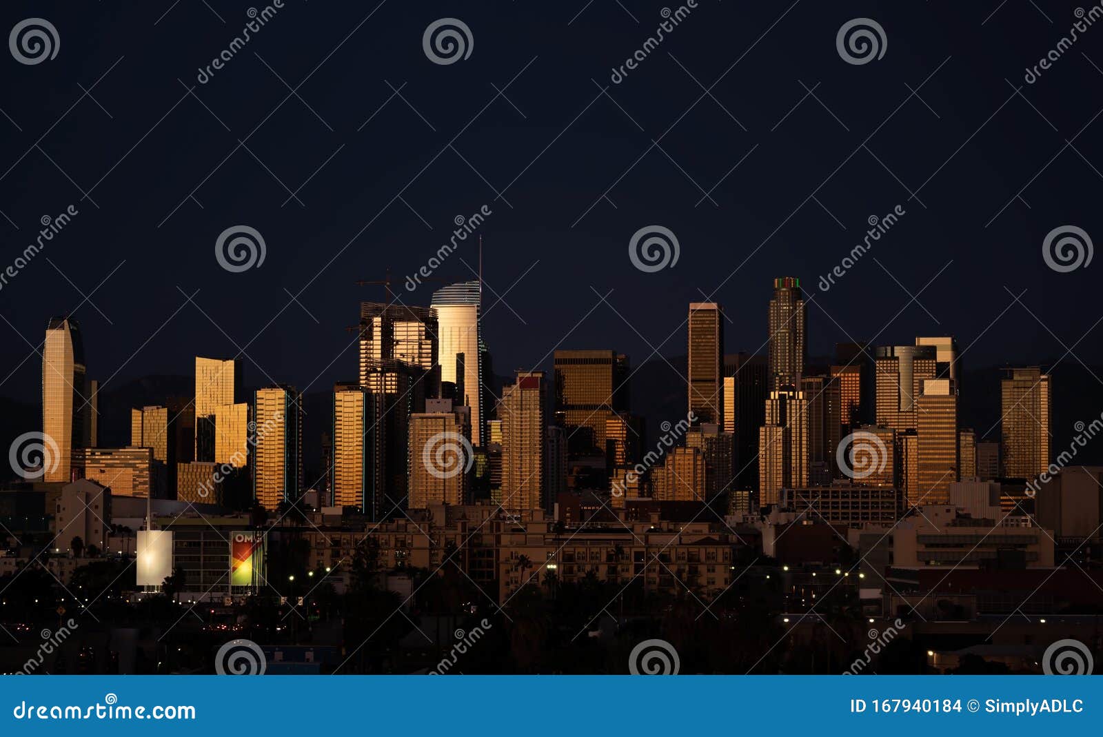 amazing night shot of los angeles downtown with highrises reflecting evening light
