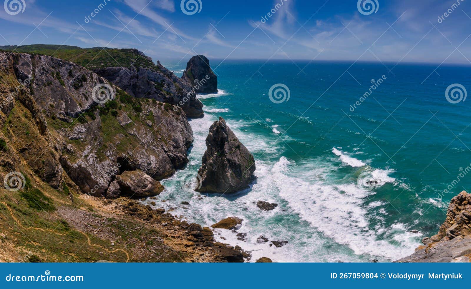 amazing panorama of rocky shore  atlantic ocean. view of high cliffs, foamy waves and sandy beach. sunny summer seascape. portugue