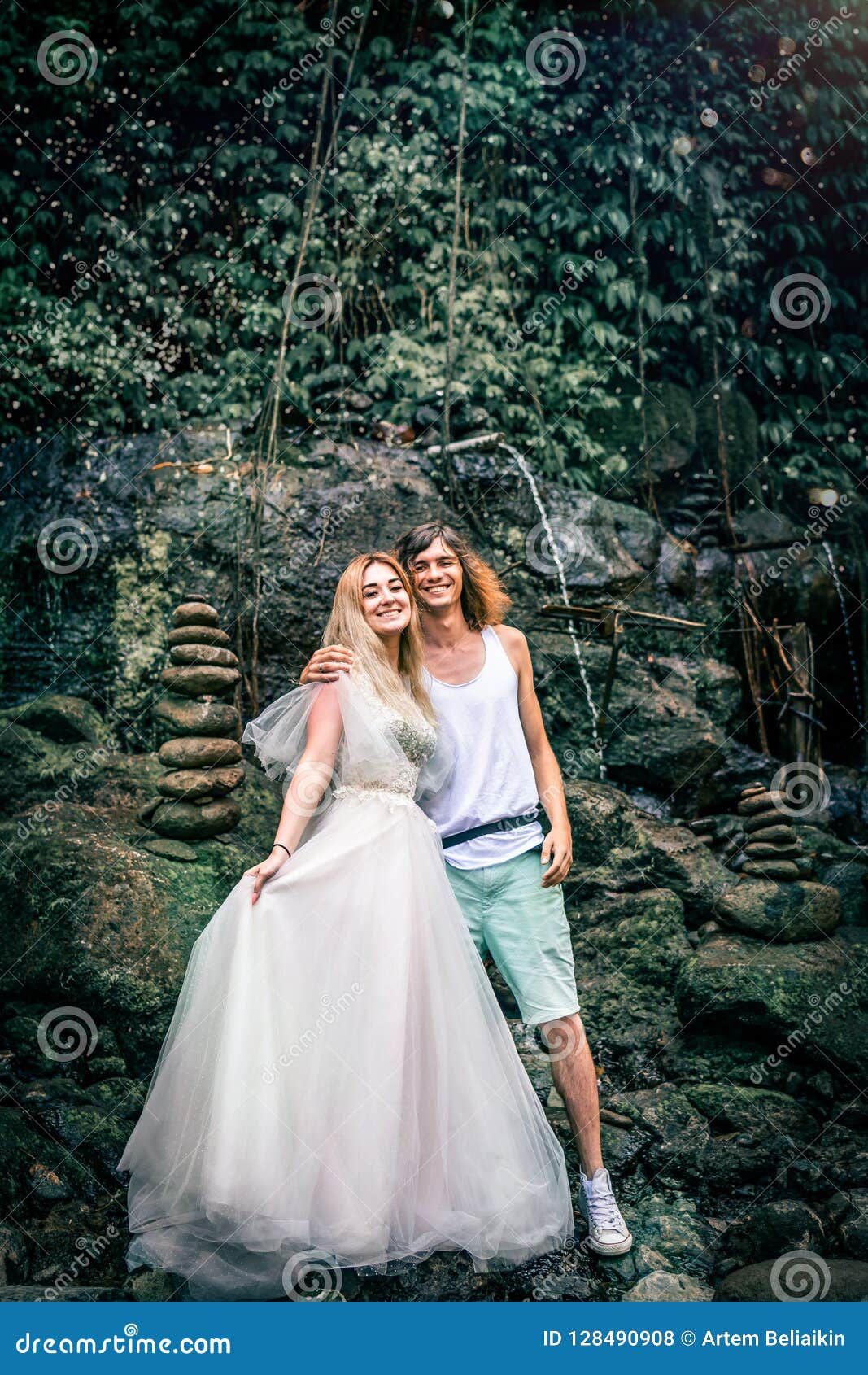 Amazing Romantic View Of Happy Couple In The Rainforest Of Bali Island Close To Waterfall Stock