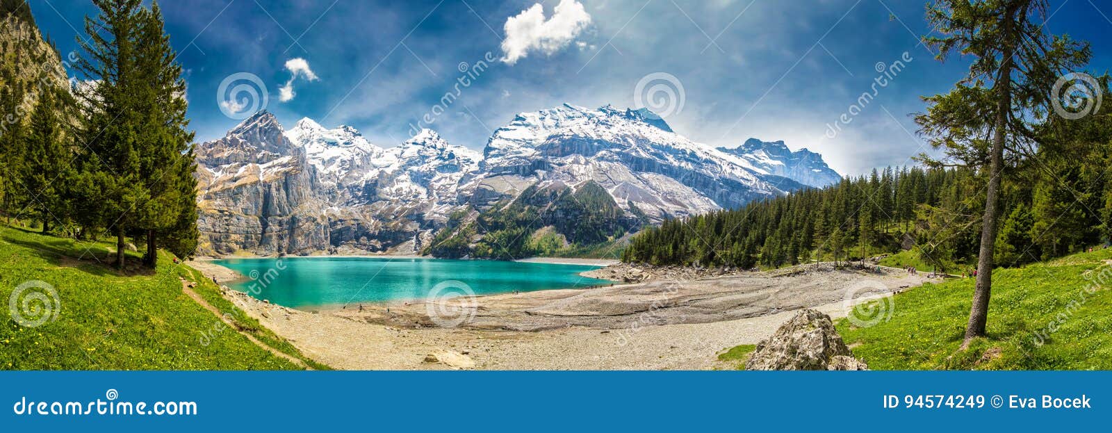 amazing tourquise oeschinnensee with waterfalls, wooden chalet and swiss alps, berner oberland, switzerland