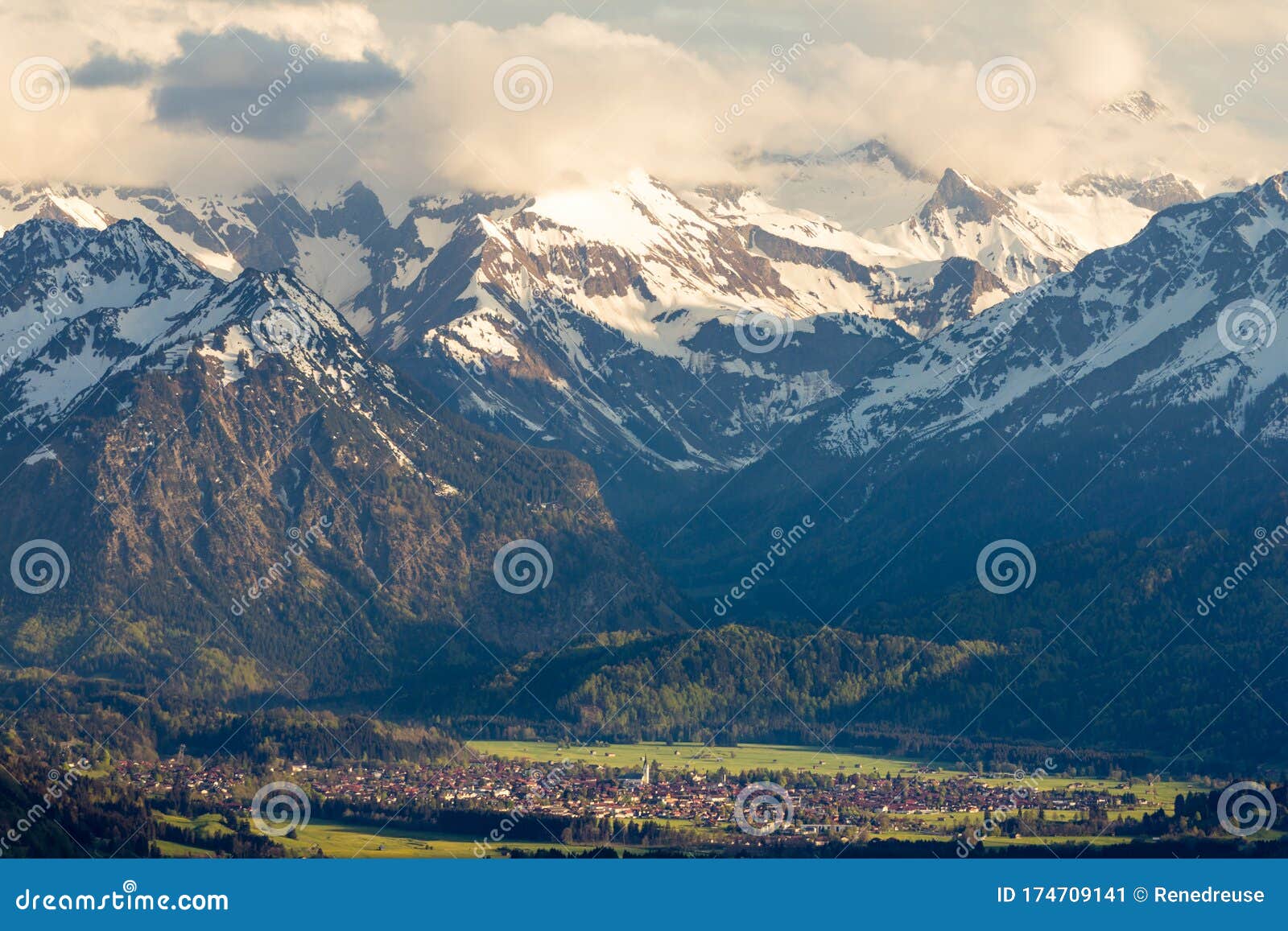 amazing view snow-covered mountains with village in valley. sunset or sunrise in oberstdorf, germany.