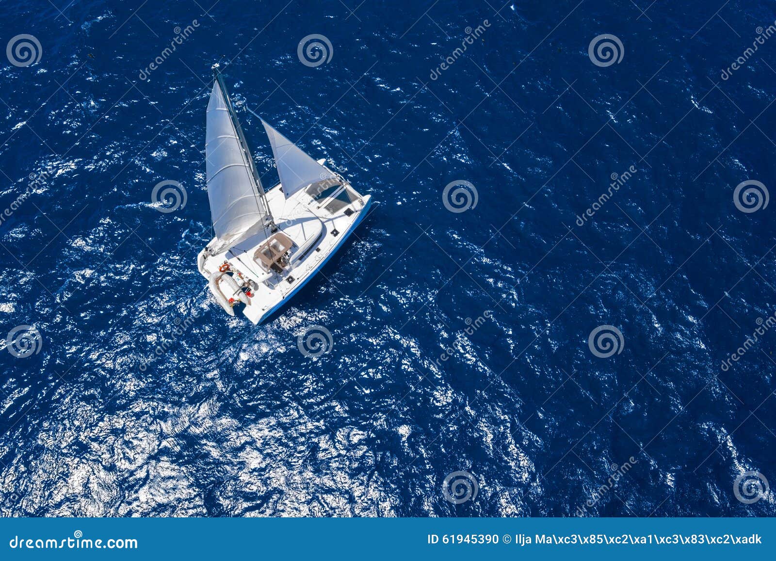 amazing view to catamaran cruising in open sea at windy day. drone view - birds eye angle