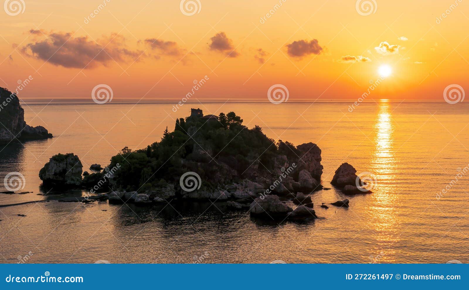 amazing view to a sunrise or sunset above beautiful isle in sea with nice coasline and clouds on the background of the evening sea