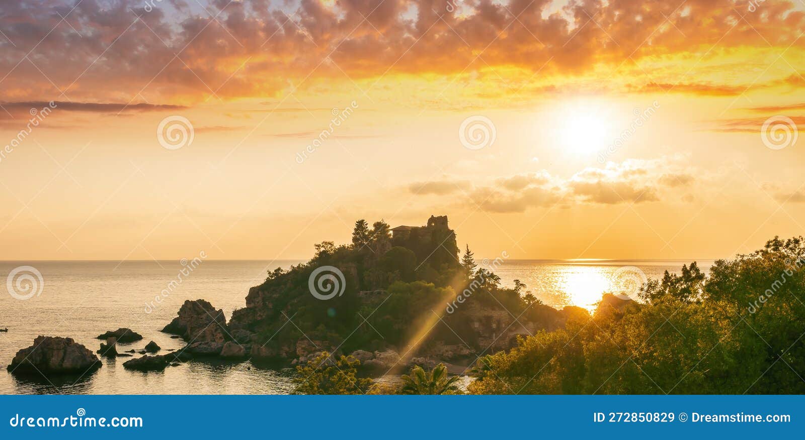 amazing view to a sunrise or sunset above beautiful isle in sea with nice coasline and clouds on the background of the evening sea