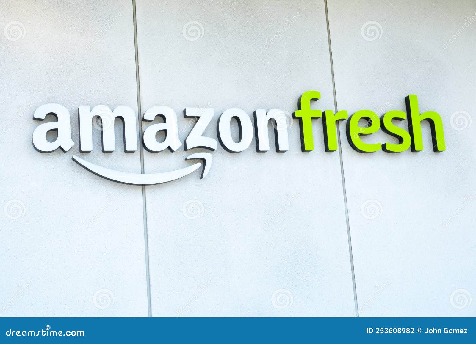 Amazon Fresh brand logo on building exterior. Canary Wharf, London, UK. 11th August 2022. Low angle view of Amazon Fresh brand logo on building exterior located at Canary Wharf.