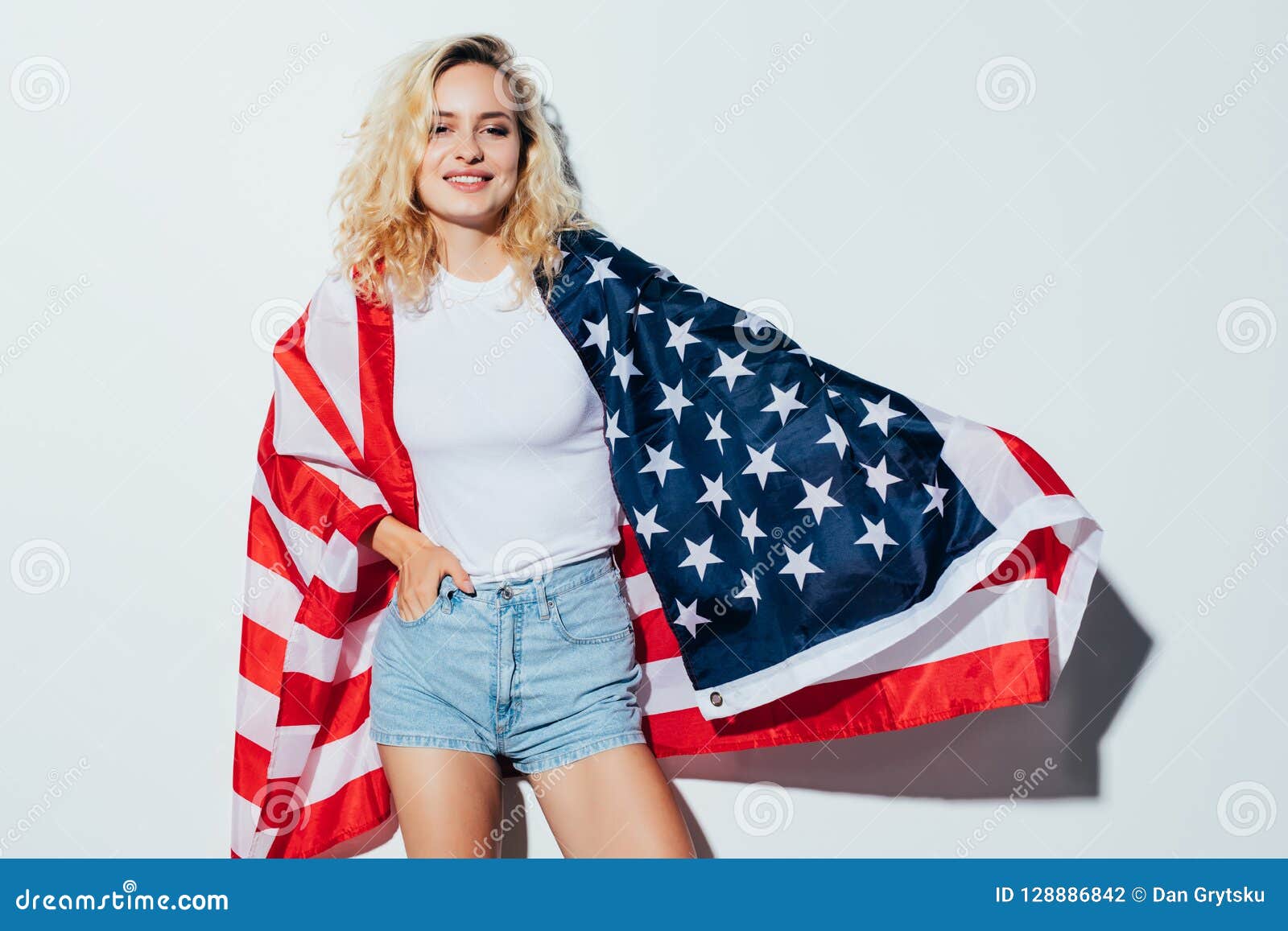 American Blonde Woman Holding The Usa Flag Isolated Over A White