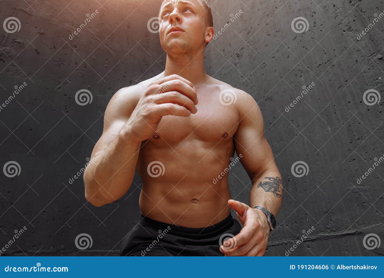 Portrait Of Confident Shirtless Boxer Wearing Protective 