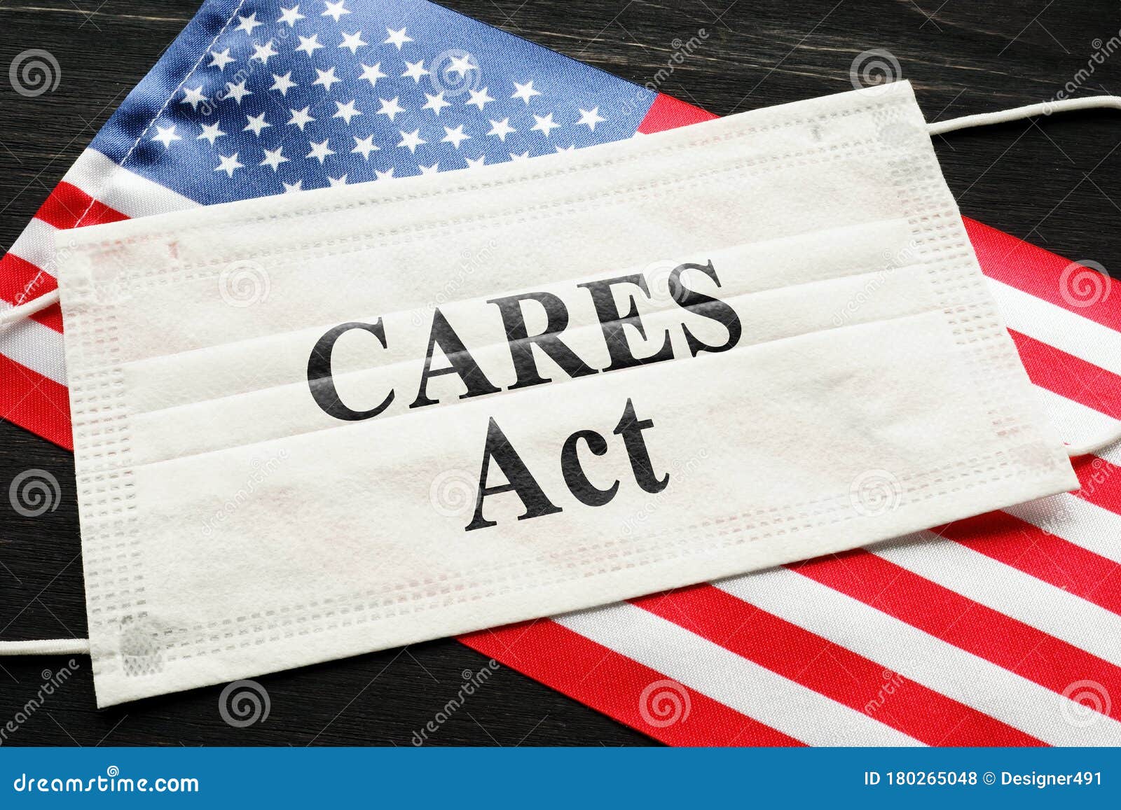american flag and mask with sign cares act. coronavirus aid, relief, and economic security law concept