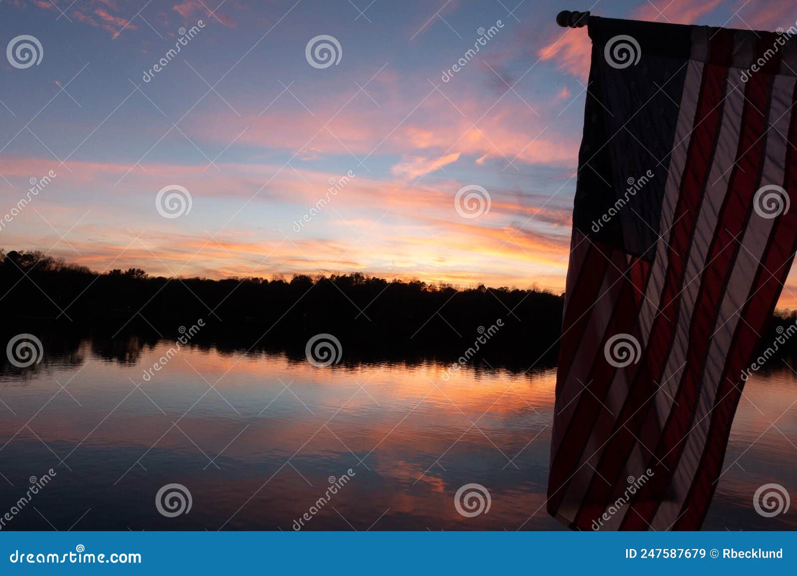 American Flag at Sunset Over a Lake Stock Image Image of blue
