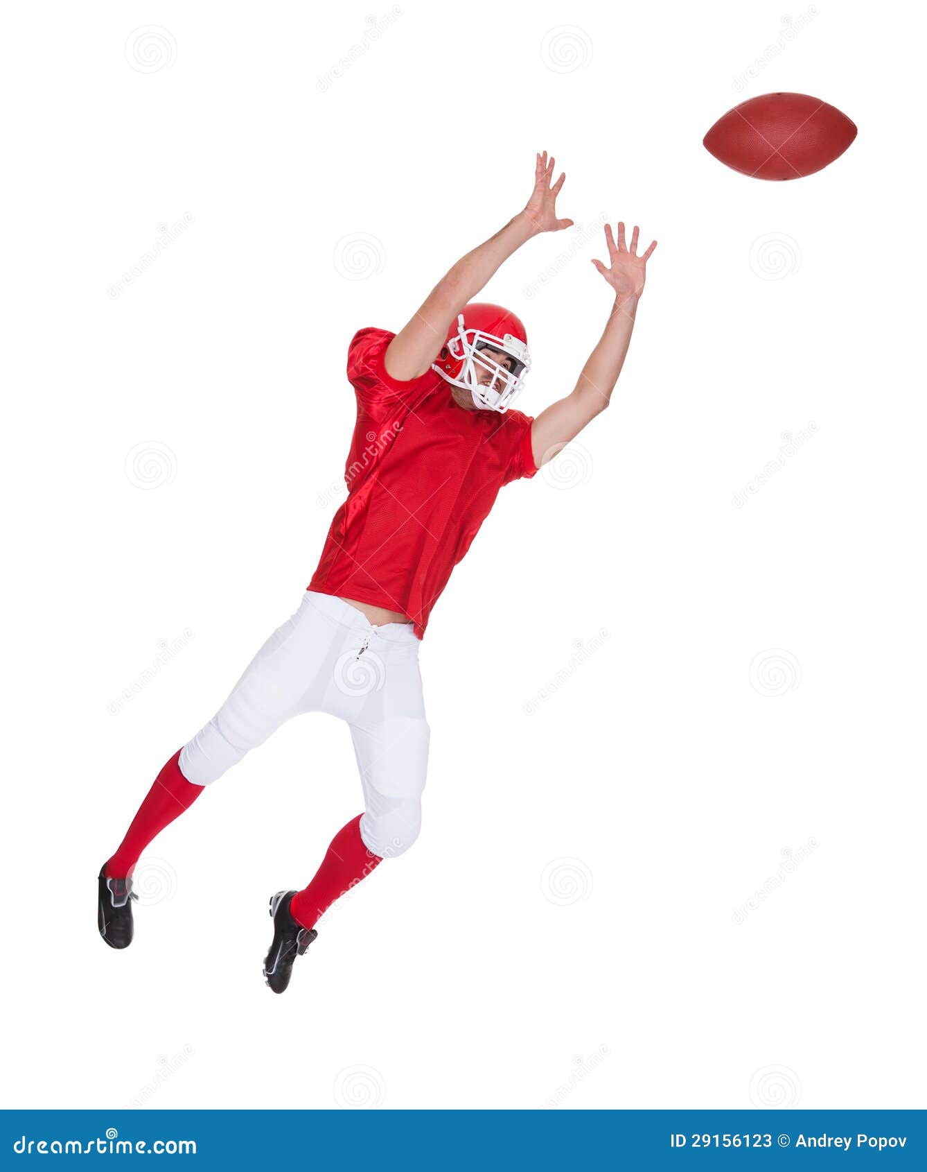 american football player catching ball