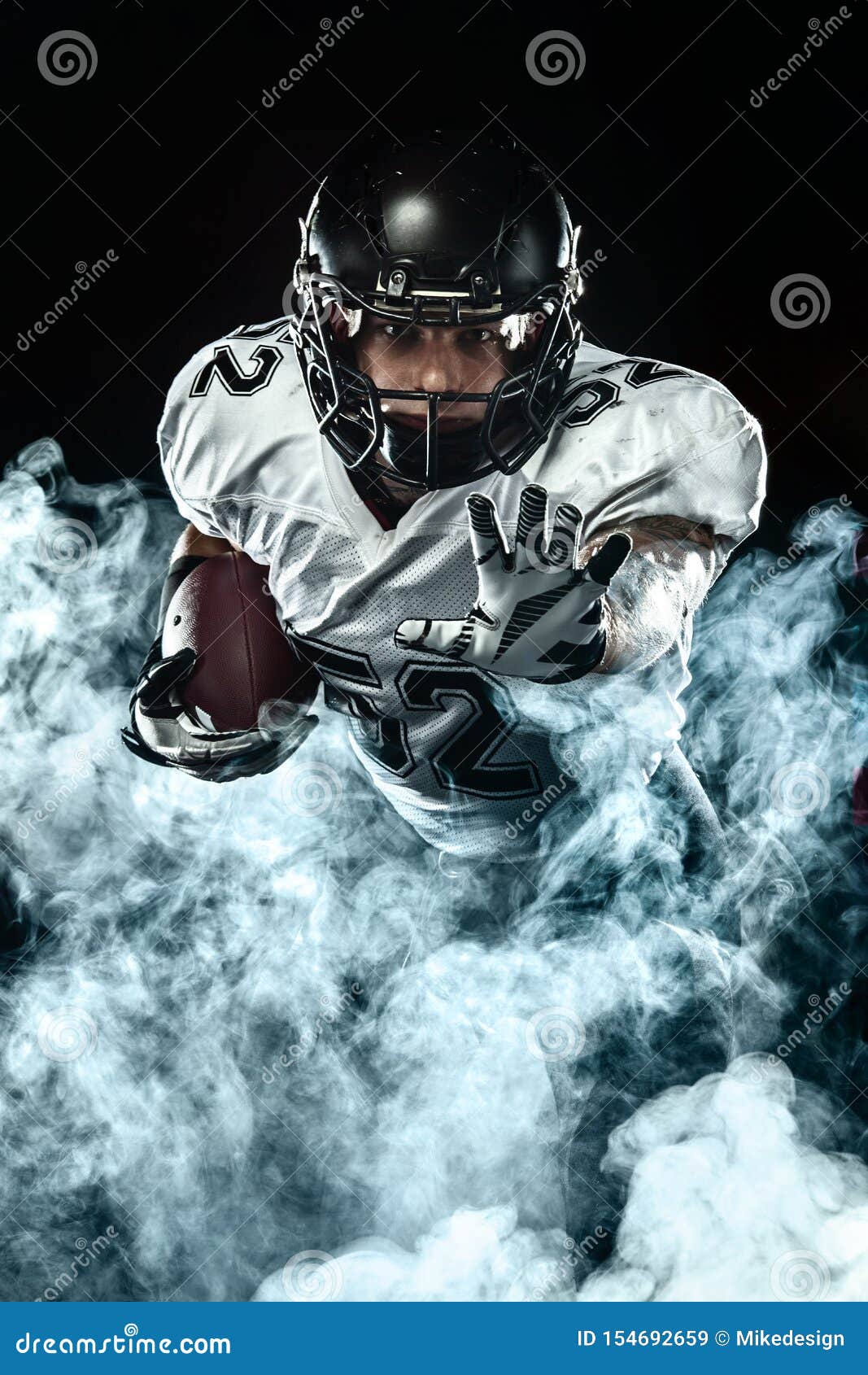 American football player in helmet, on the stadium field with ball in the  hand. Dark background. Team sports. Black and whit sport wallpaper with  double exposure. Stock Photo | Adobe Stock