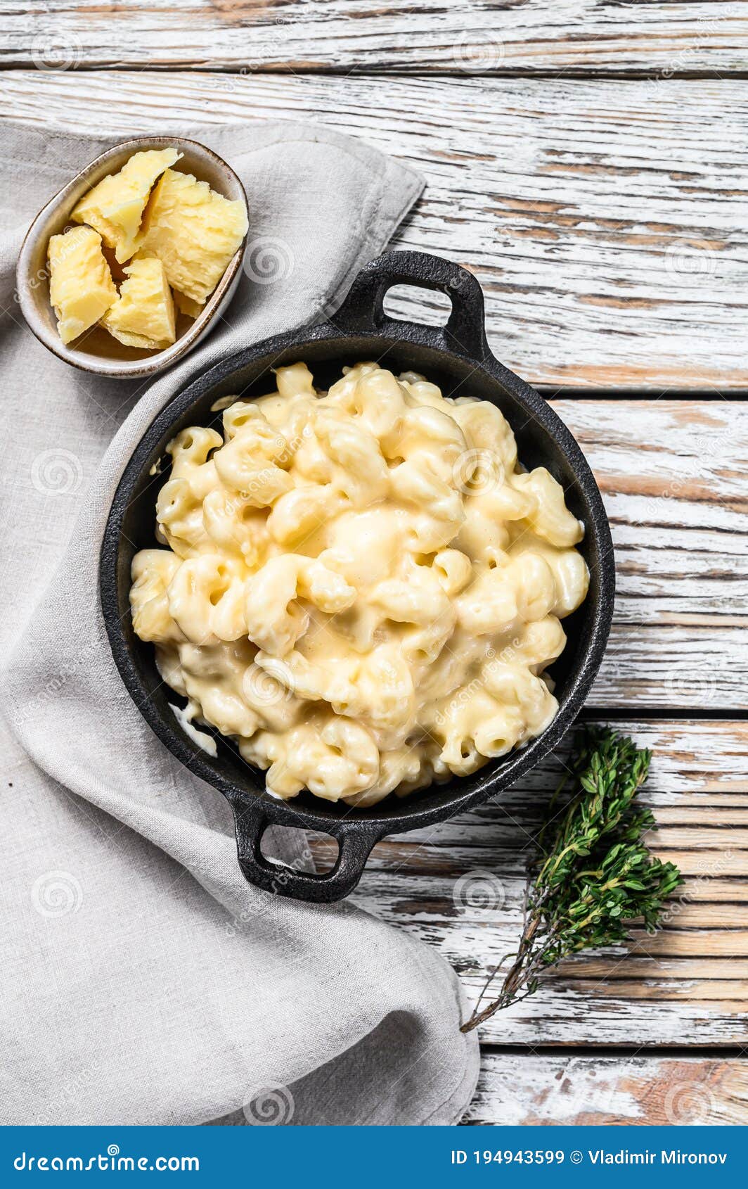 american mac and cheese, macaroni pasta in cheesy sauce. white wooden background. top view