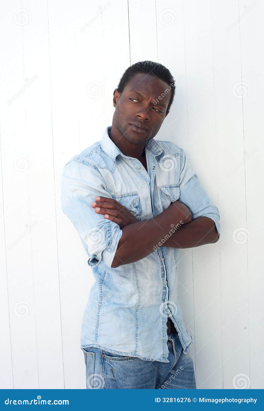 American Man Leaning Against Wall With Arms Crossed Stock Photo - Image