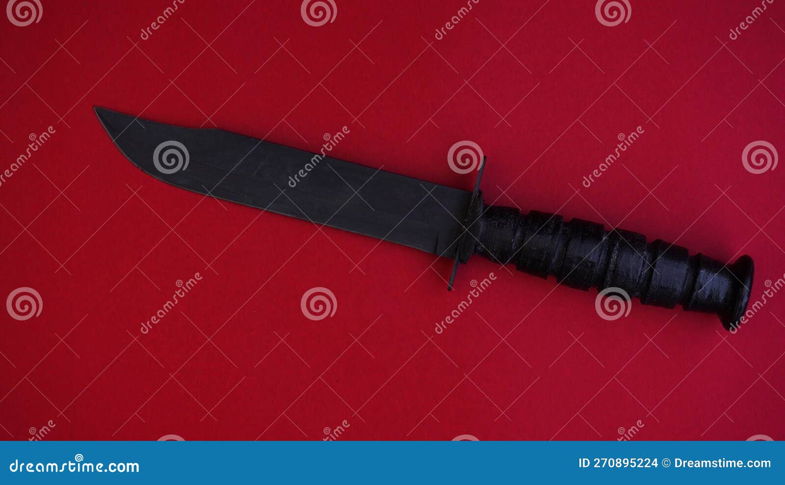 american military combat knife on a red background