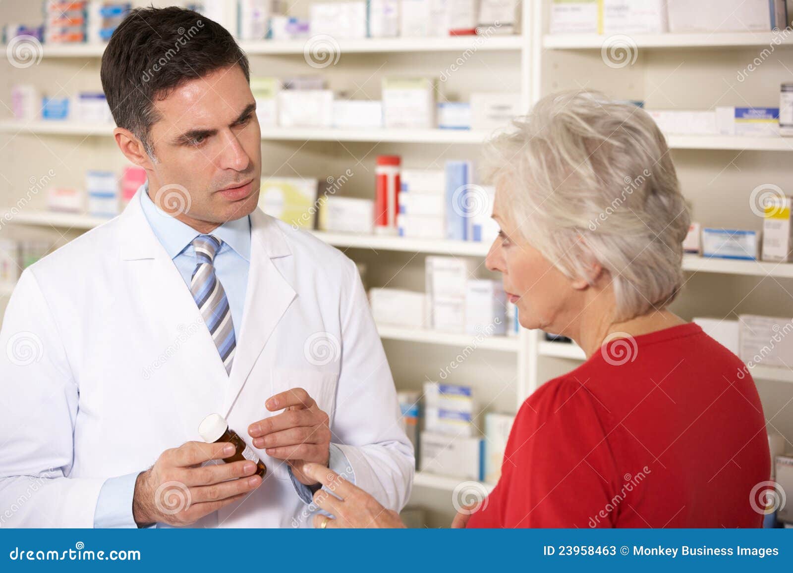 american pharmacist with senior woman in pharmacy