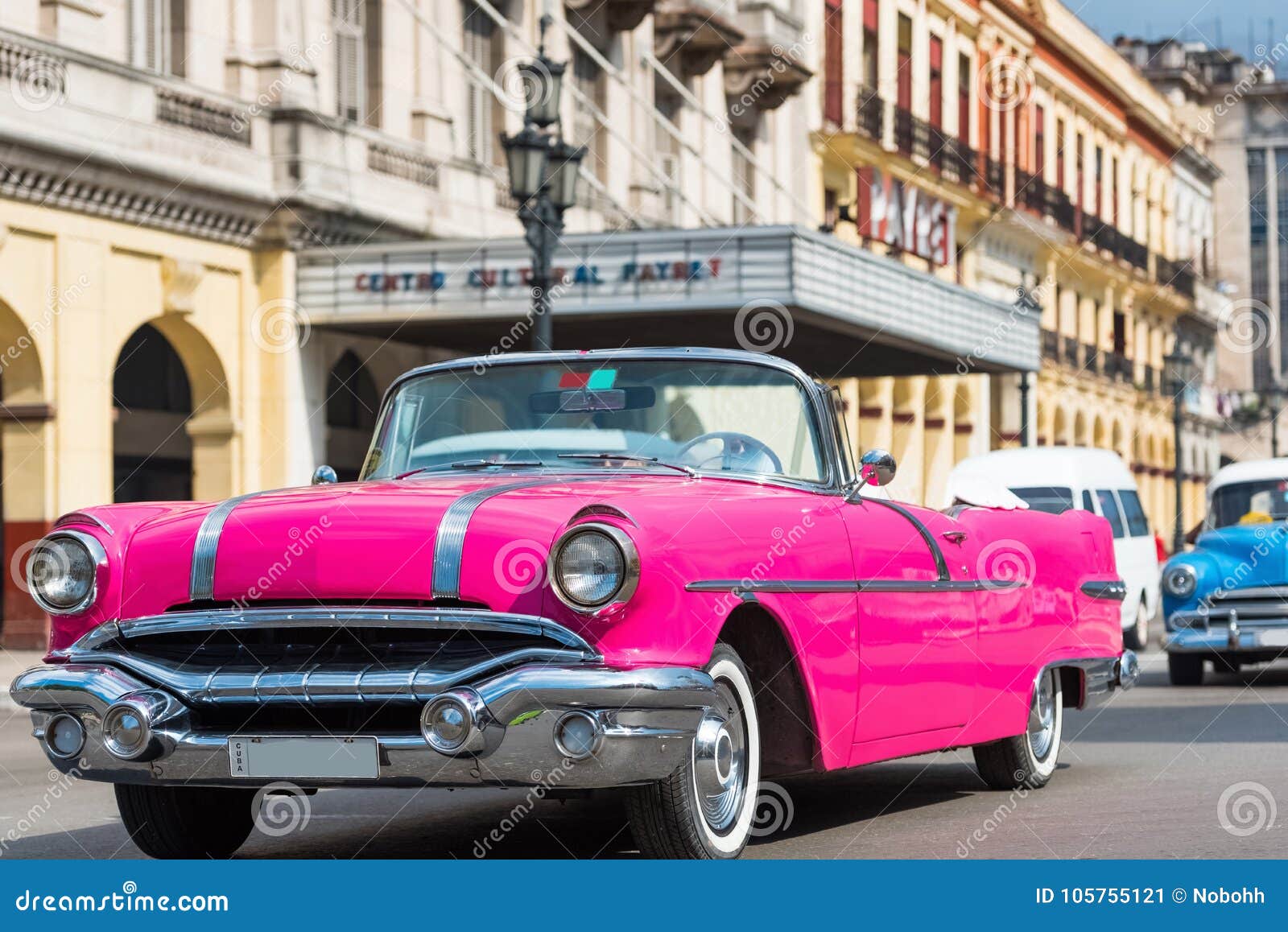 american pink convertible pontiac classic car drive with tourists through havana cuba - serie cuba reportage
