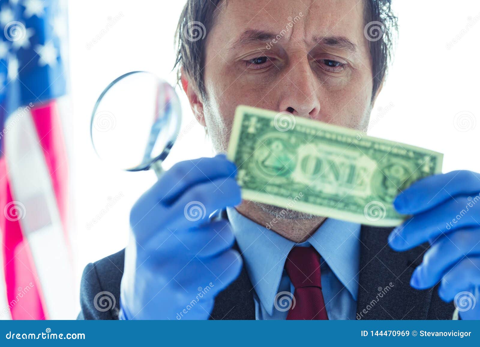 American Secret Service Agent Analyzing Suspicious Counterfeit Dollar