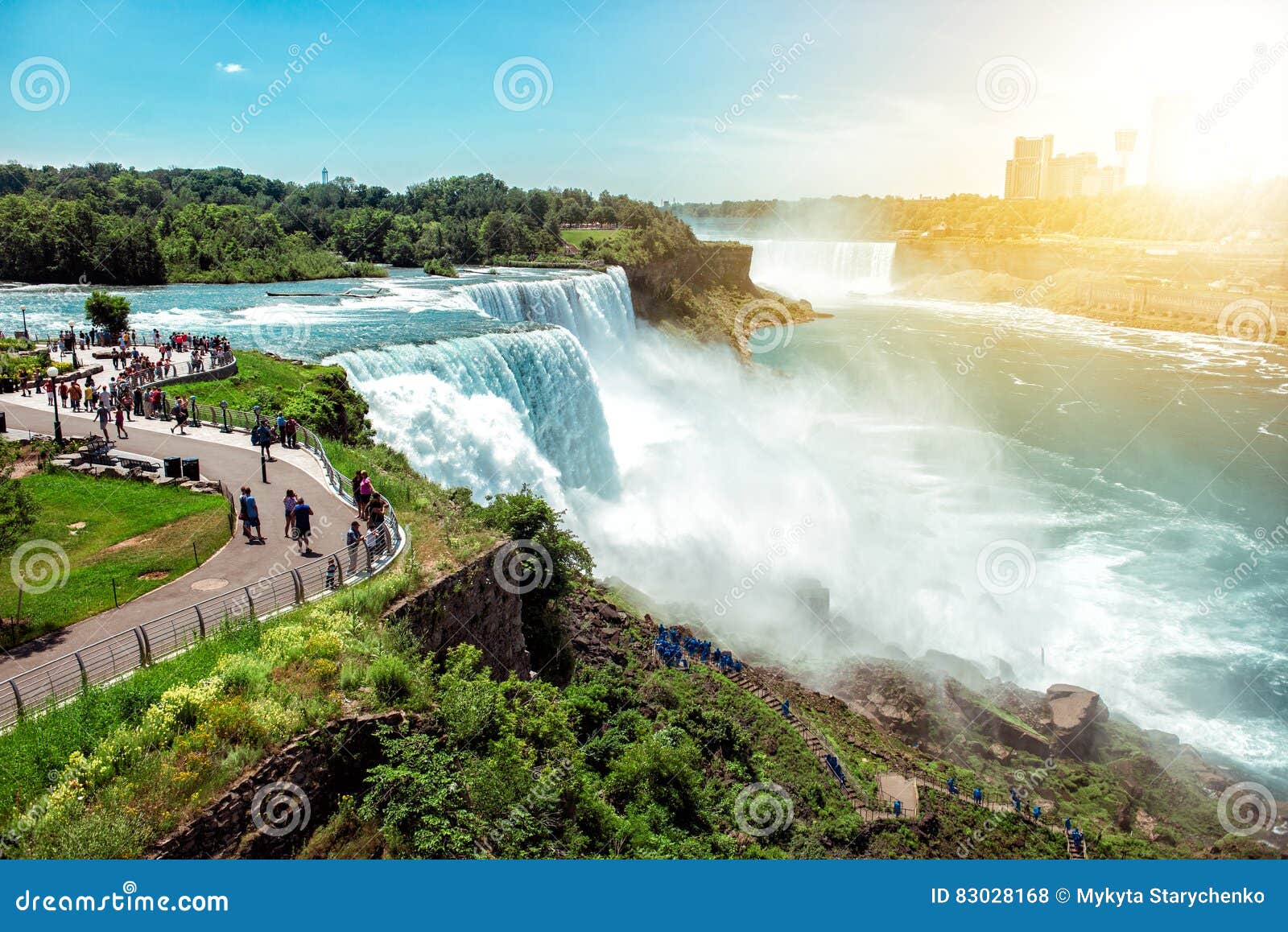 american side of niagara falls, ny, usa. tourists enjoying beautiful view to niagara falls during hot sunny summer day