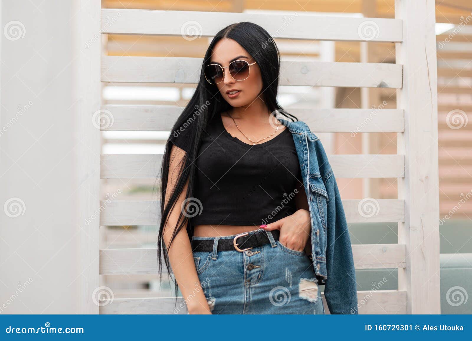 a young very beautiful woman in a black T-shirt denim jacket and