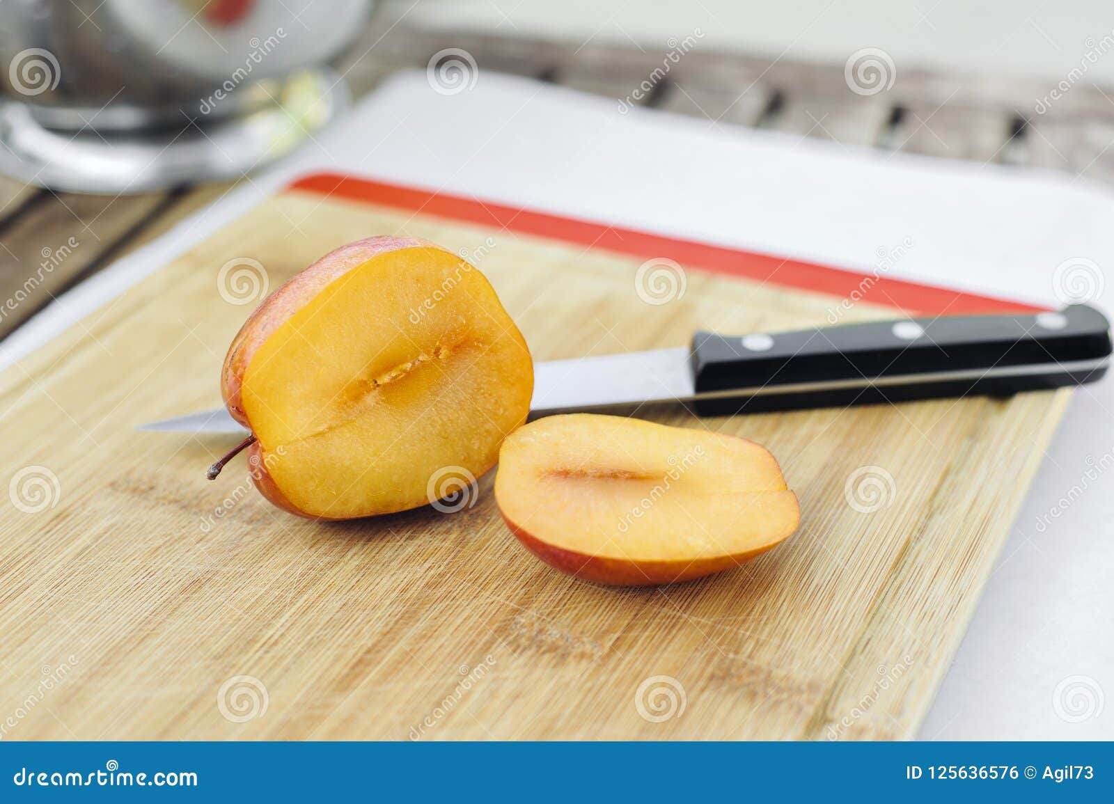 amigo pluot sliced open with a knife