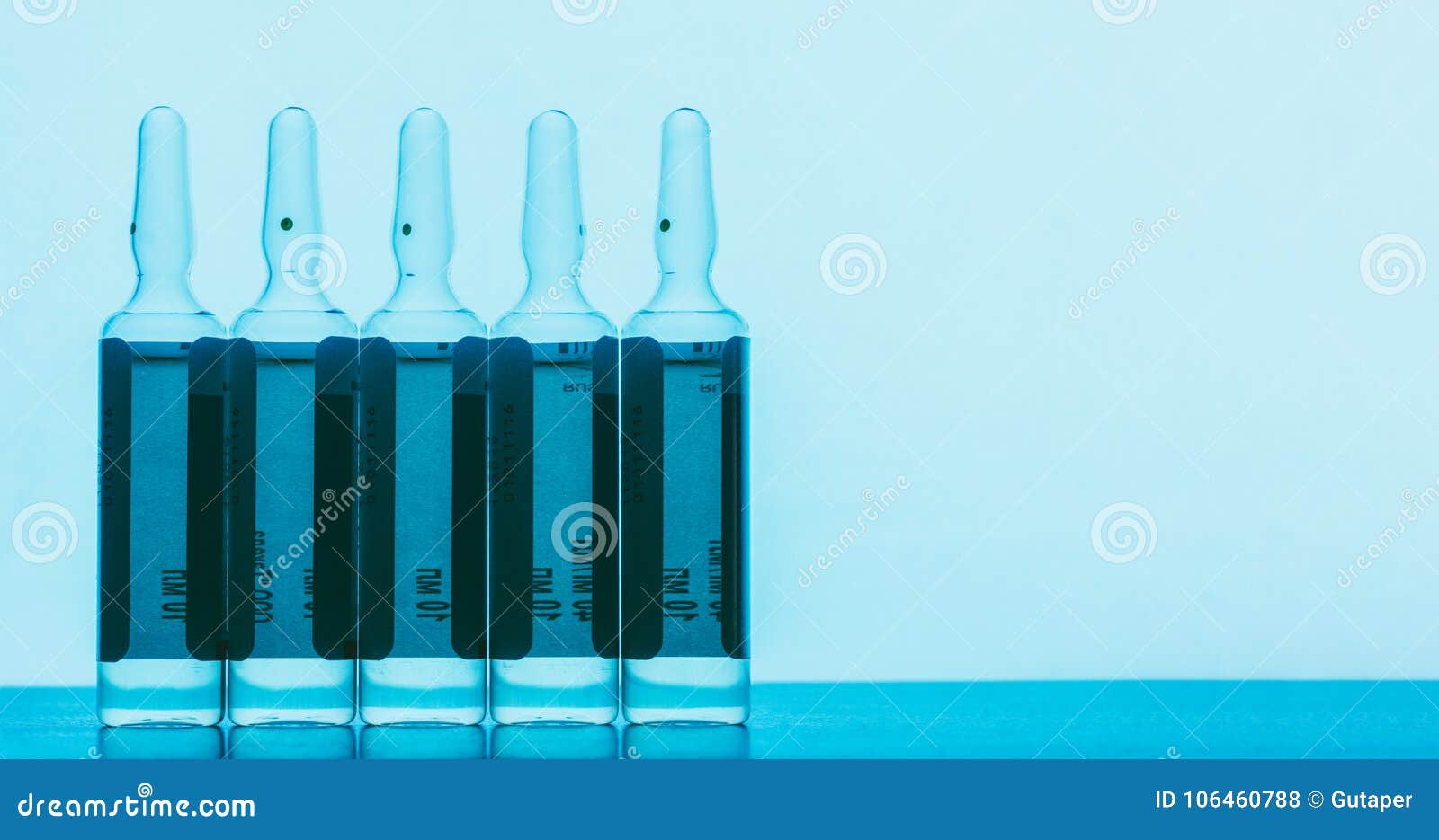 The Ampoules with Solution for Injections on a Blue Background Stock