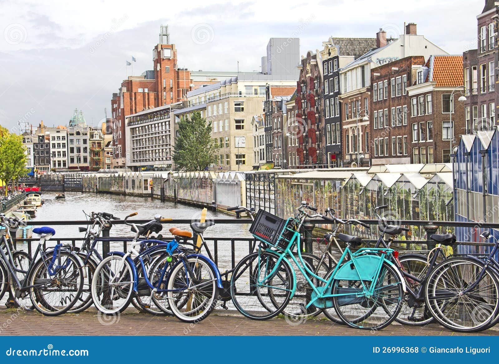Amsterdam canal and bikes stock photo. Image of bike 26996368