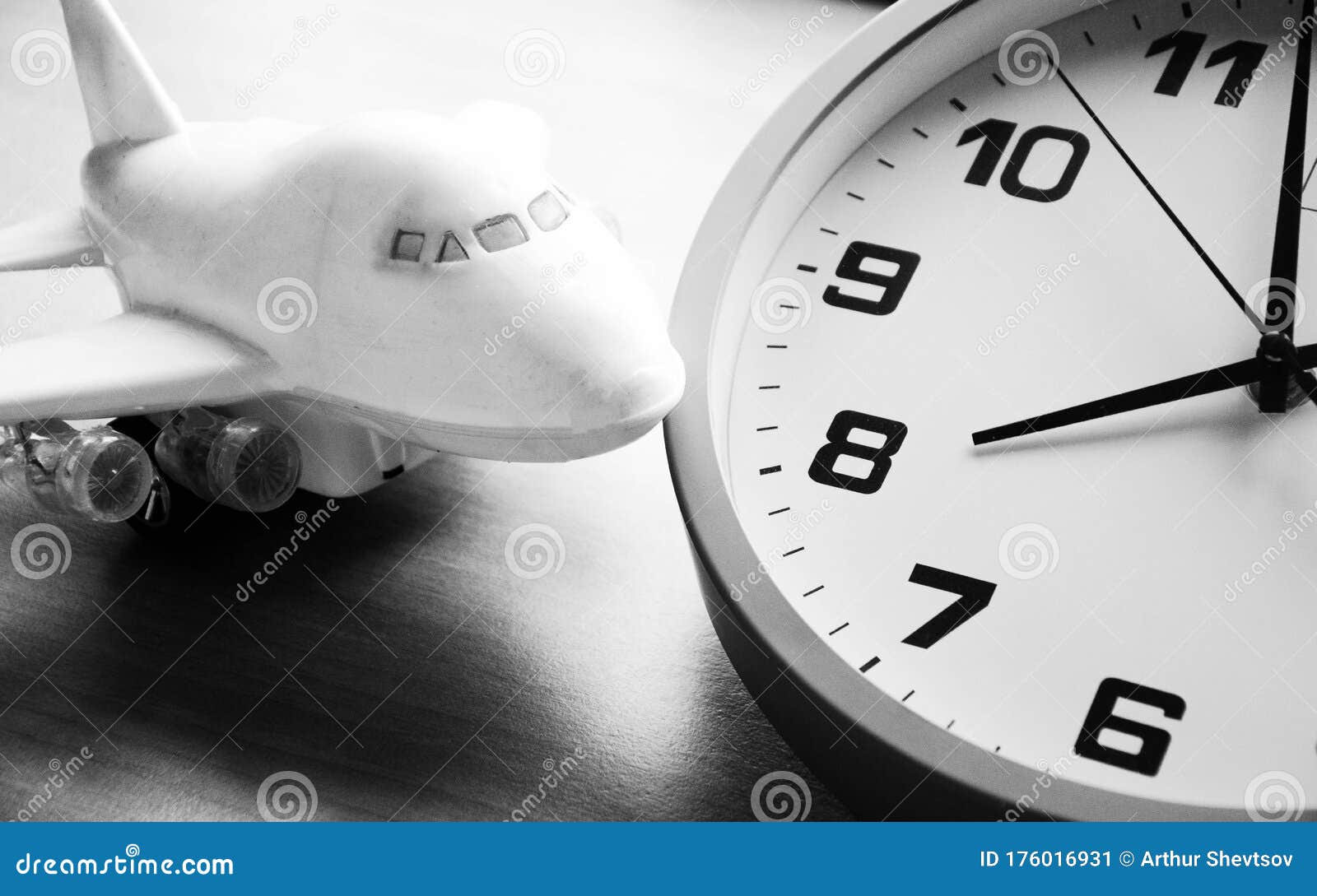 Analog Clock and Passenger Plane. a Toy Airplane Next To an Analog