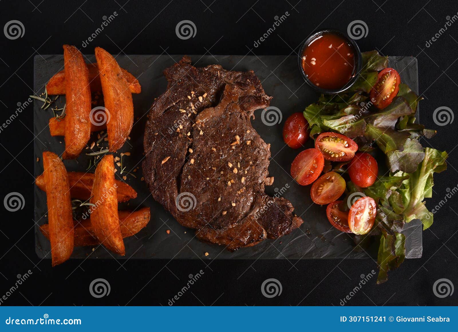 ancho beef steak with rustic roast potatoes and salad with herb dressing