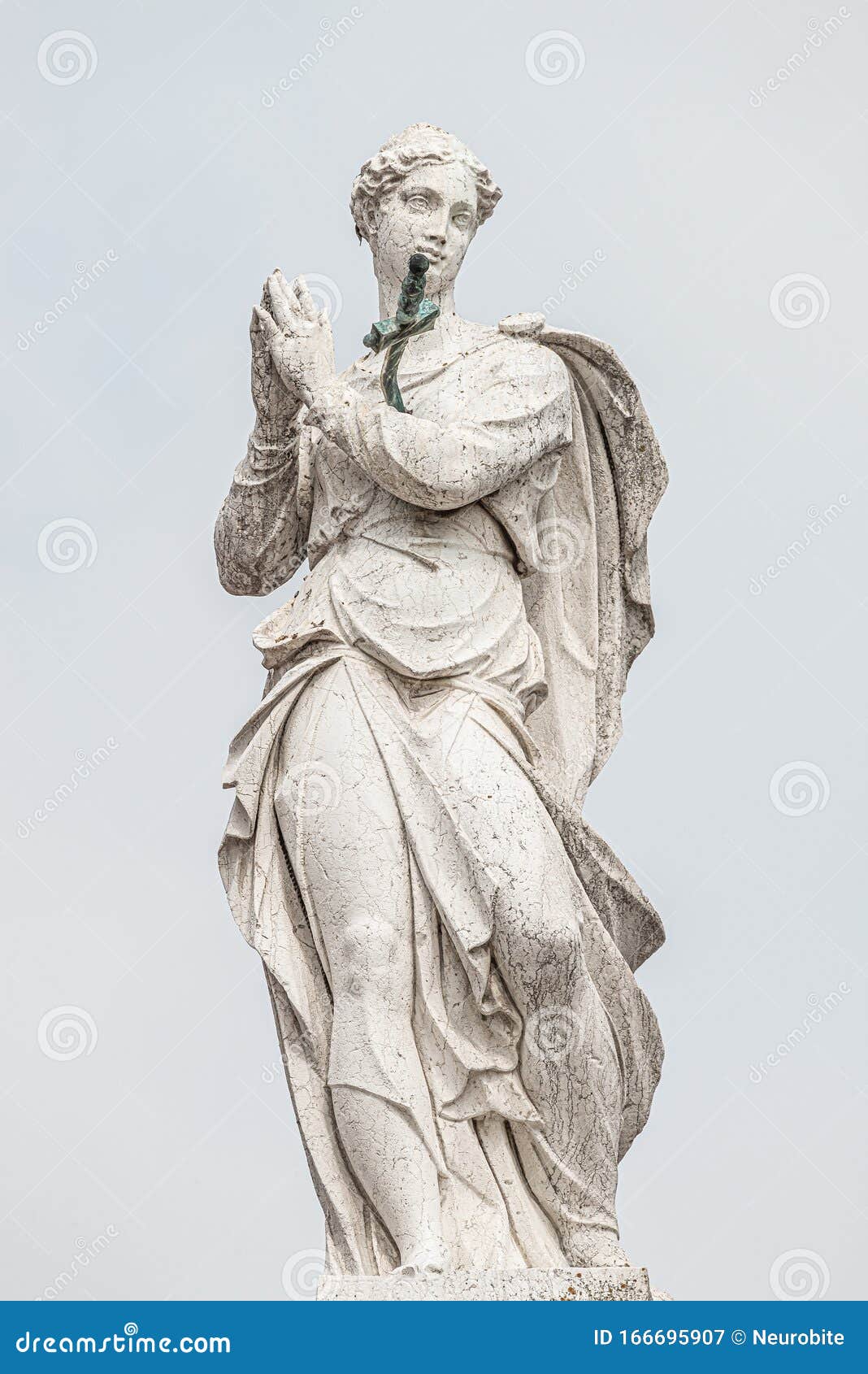 ancient aged sculpture of beautiful praying angel with wings at roof of santa maria assunta jesuits church in venice, italy,