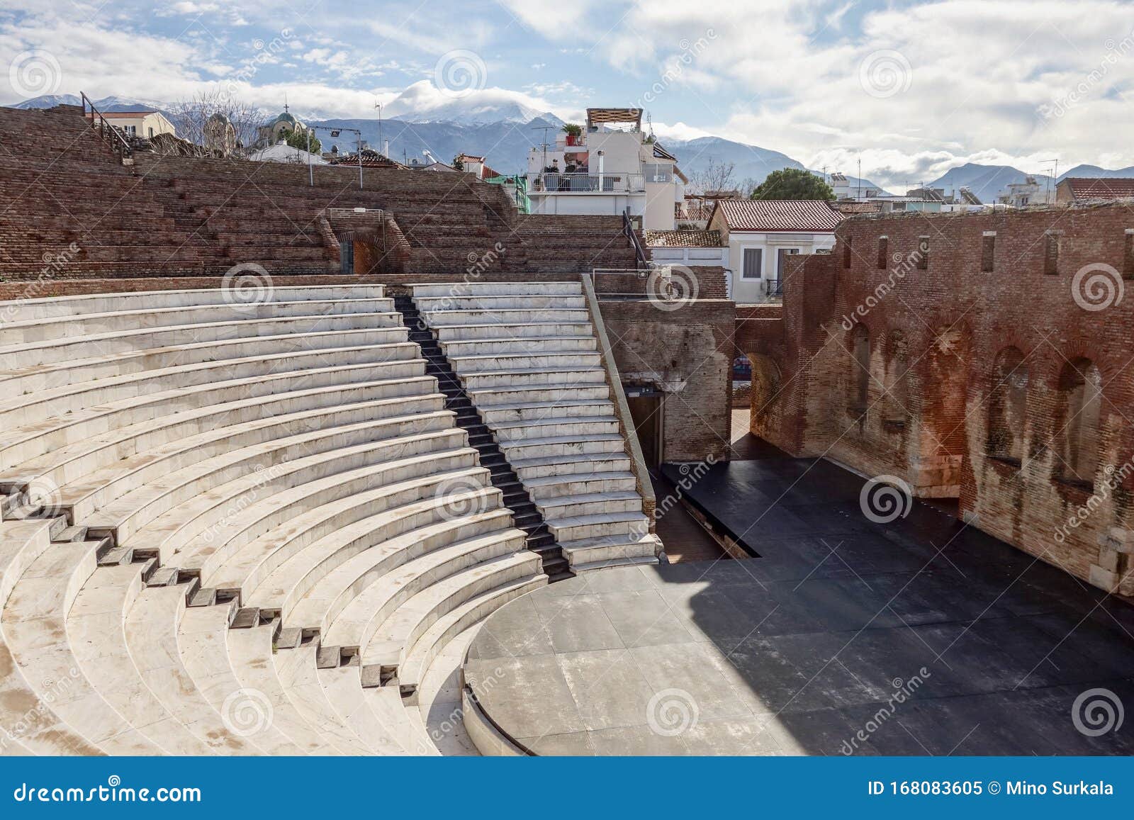 auditorium, stage and wall of the roman odeon patra romaiko odio patras in greece with a morning shadow with blue sky