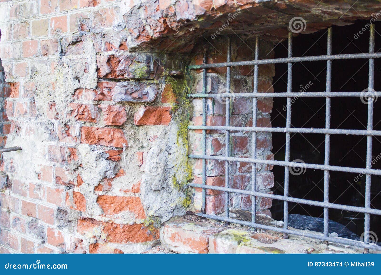 Ancient Brick Wall And Window Locked With Metal Bars Stock Photo