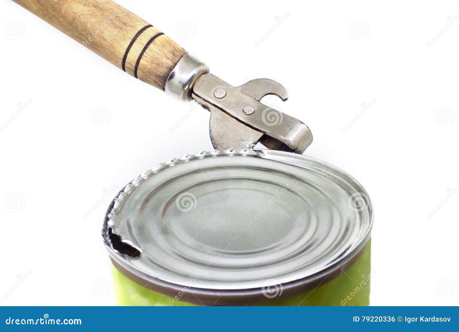 Old style tin opener opening a can, isolated on white background