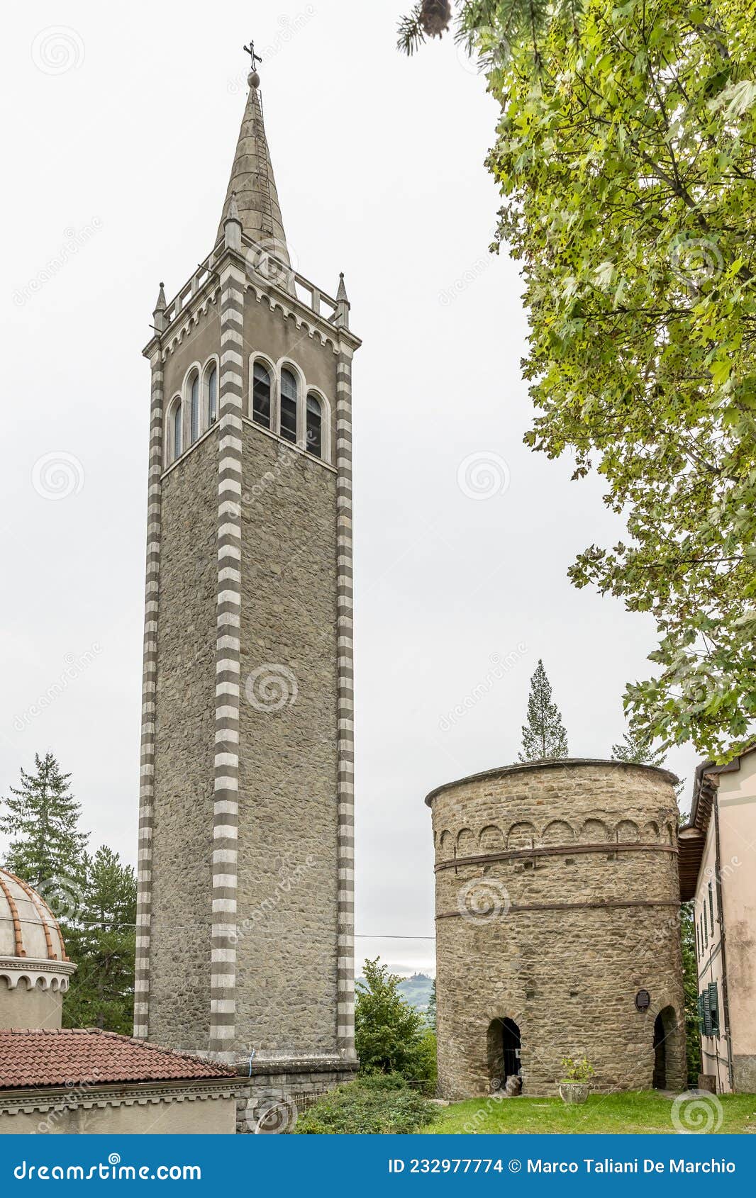 the ancient delubro and the bell tower of the parish church, in the historic center of lizzano in belvedere, italy