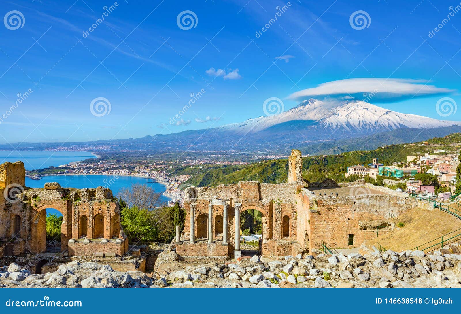 ancient greek theatre in taormina on background of etna volcano, italy