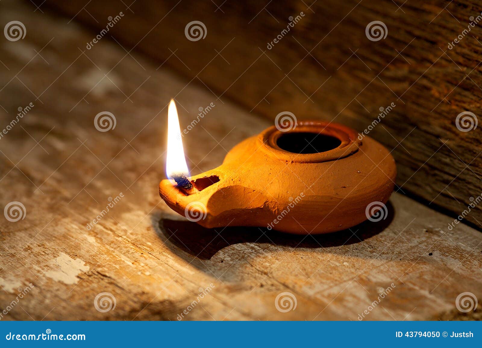 ancient middle eastern oil lamp made in clay on wood table