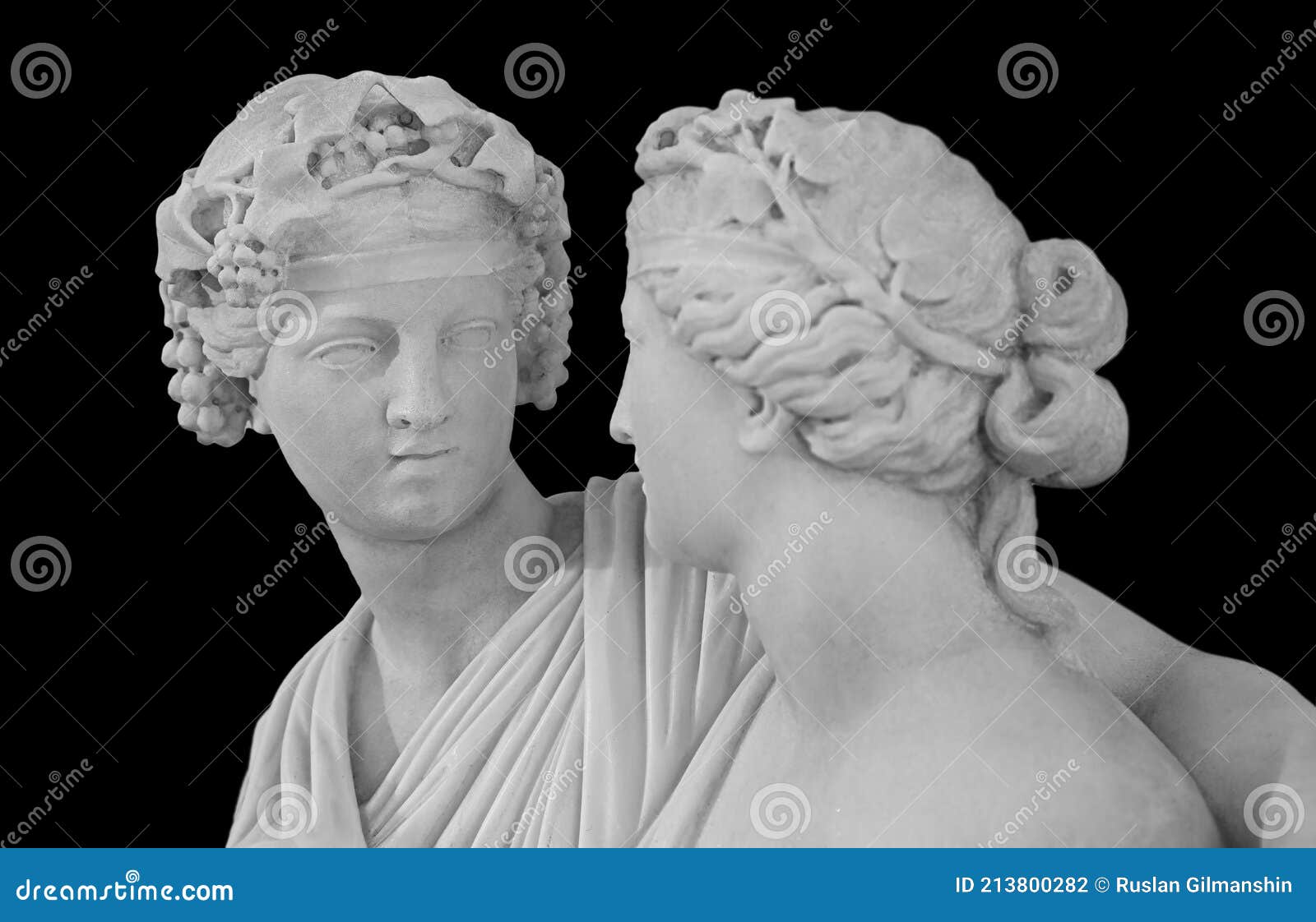 ancient sculpture of bacchus and ariadne. marble man and woman statue  on black background.
