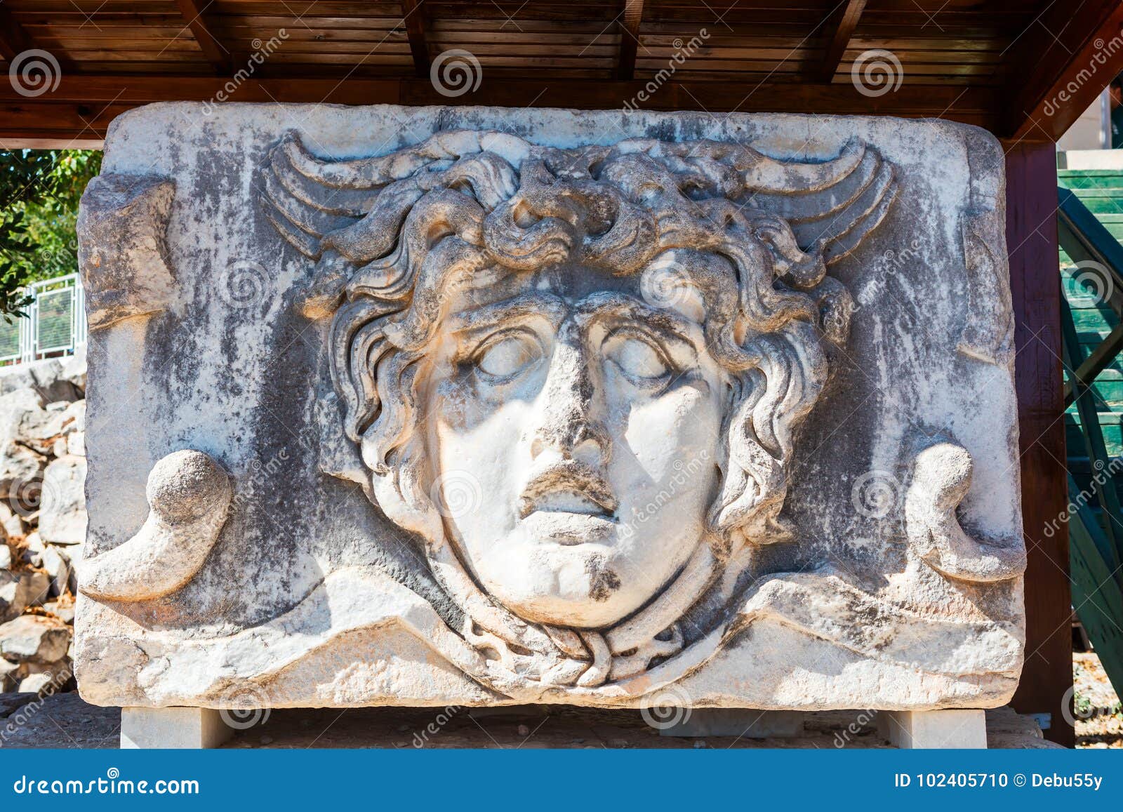 ancient stone carving of medusa head.