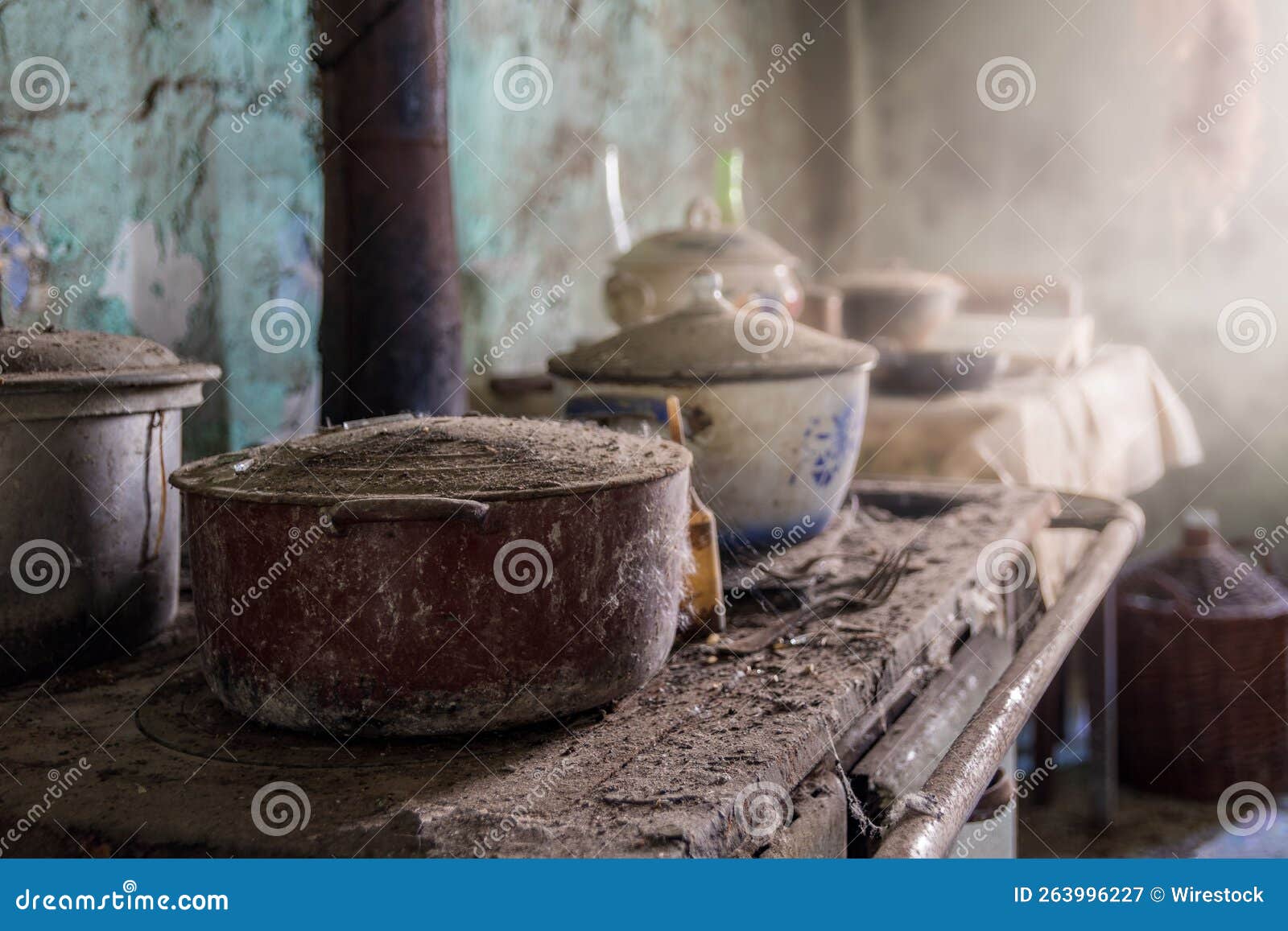 Ancient Stove with Dust Covered Pots in an Old Dirty Kitchen Stock