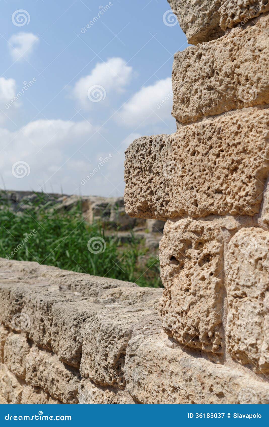 ancient weathered stone wall in archeological park in israel