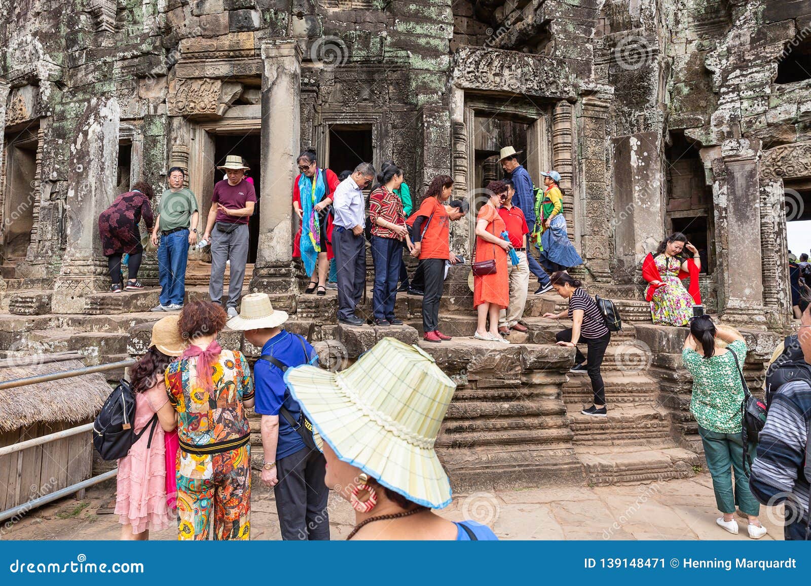 Tourists walk as they visit Angkor Wat temple in Siem Reap 