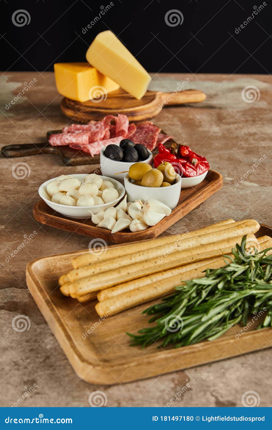 Angle View of Antipasto Ingredients on Boards on Brown Surface Isolated