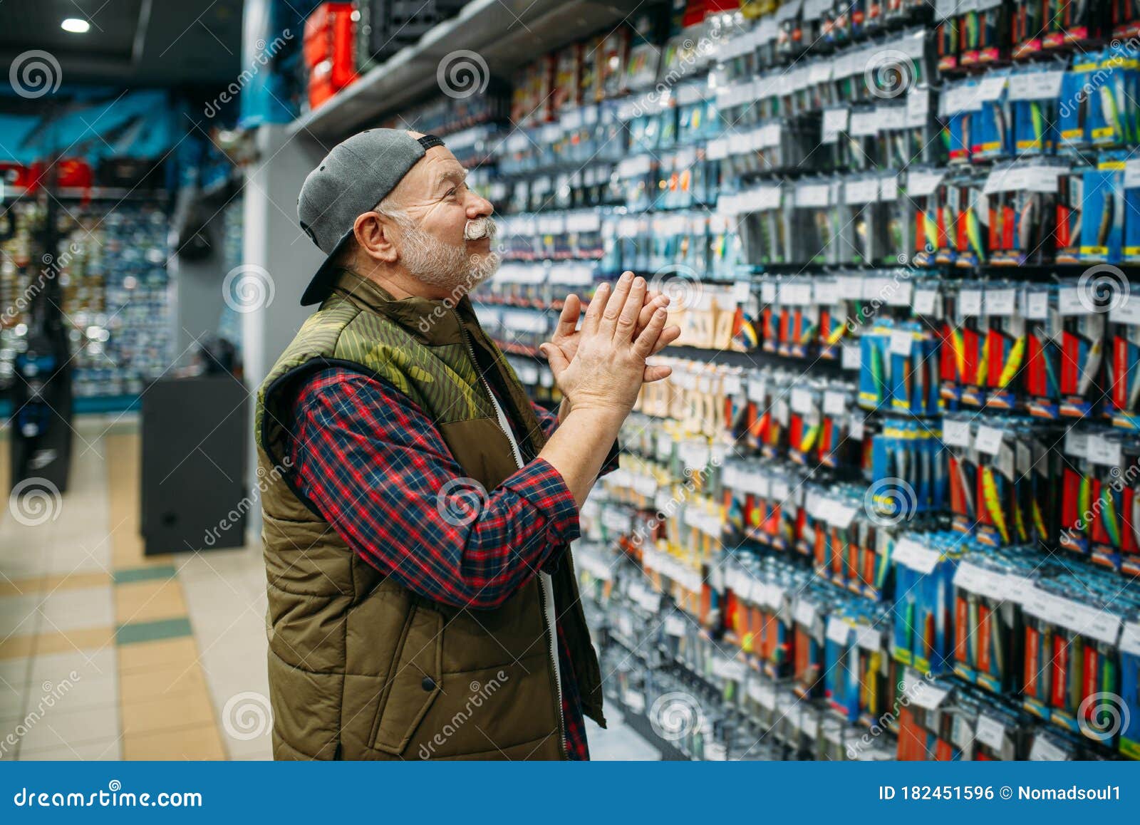 Angler Choosing Hooks and Baubles in Fishing Shop Stock Photo