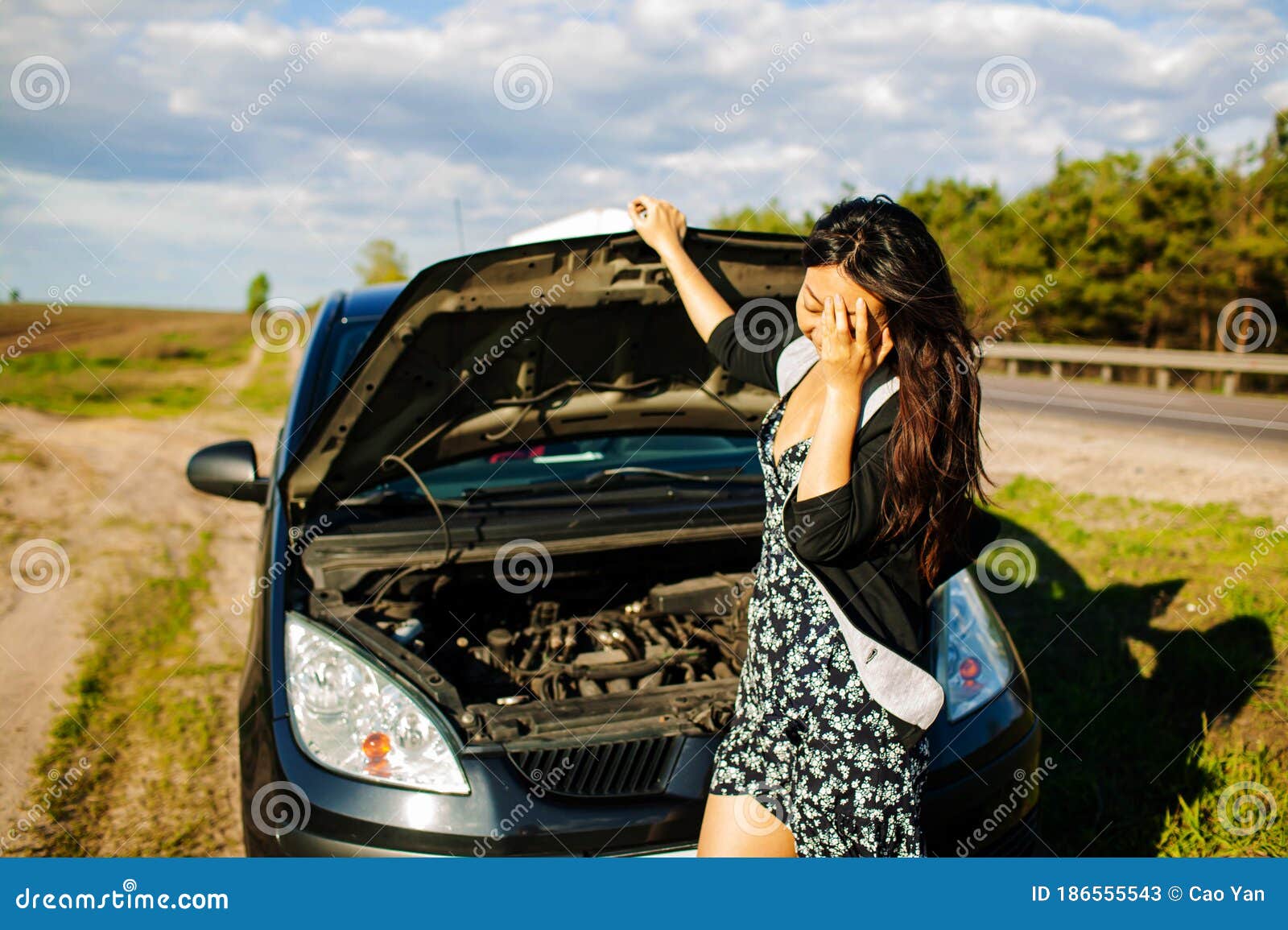 Woman Having Car Trouble And Using Cell Phone To Call For Help Stock