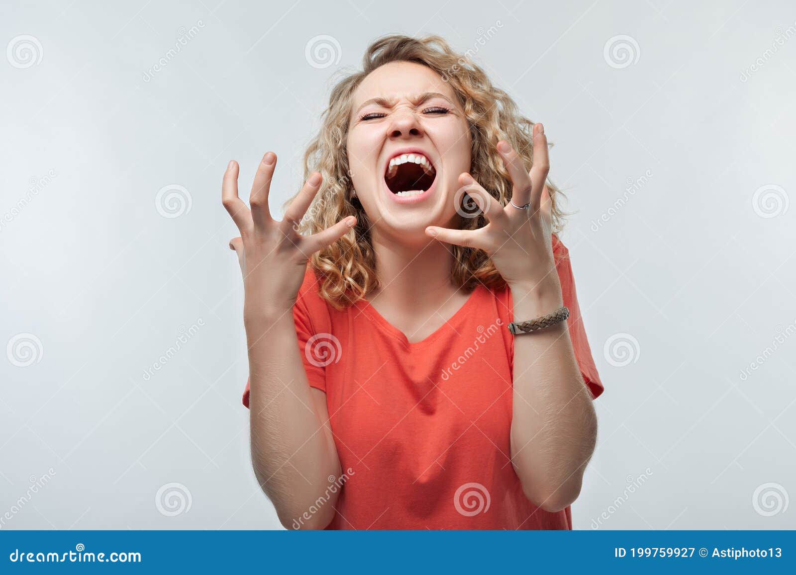 Angry Blonde Woman Screaming And Raising Hands In Anger Negative
