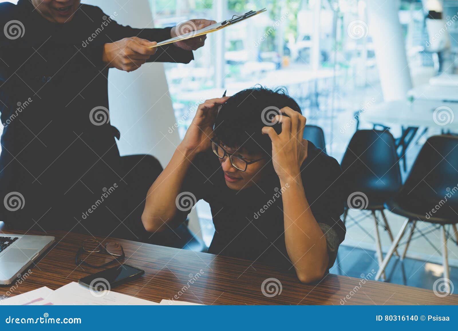 Angry Boss Hitting Employee with Document in Office Stock Photo Image