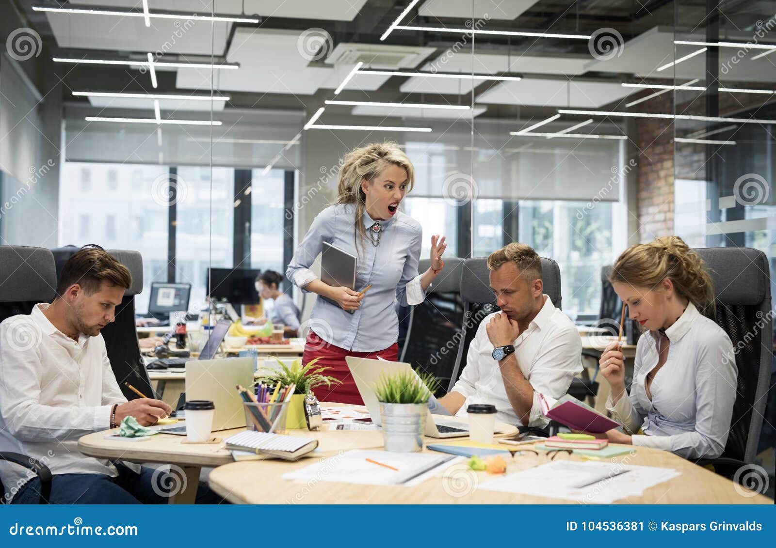 angry boss yelling at her co-workers