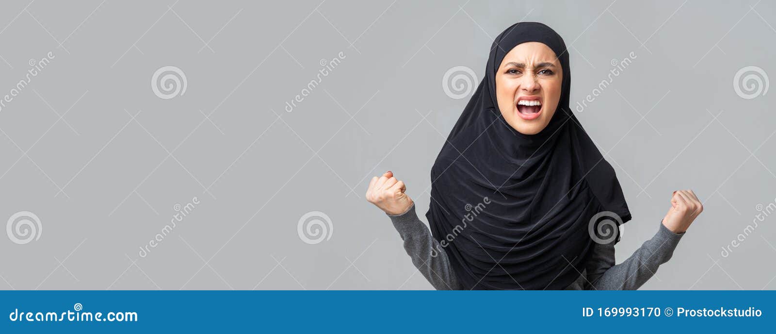 Angry Emotional Arabic Girl Screaming In Fury Over Gray Studio